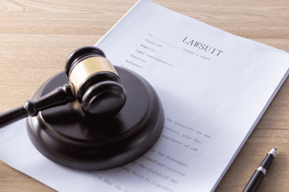a wooden judge's gaven sitting on top of a piece of paper.